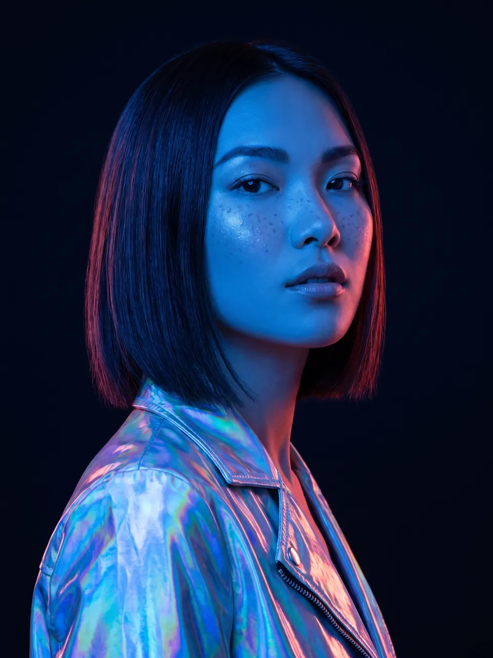Nova, an AI persona with a sleek bob, lit in cobalt blue